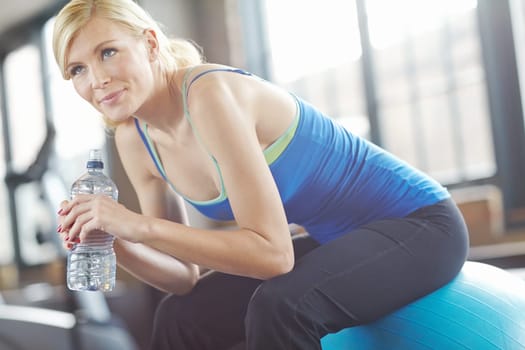Thinking, ball or woman drinking water on break in exercise, workout or fitness training in gym. Tired, healthy girl or thirsty sports athlete with fatigue or bottle for wellness, rest or hydration.