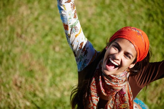 Woman, excited and portrait for outdoor with freedom in nature for summer, outdoor and adventure on grass. Young person, laugh and bohemian style with win for happiness, joy and above in garden.