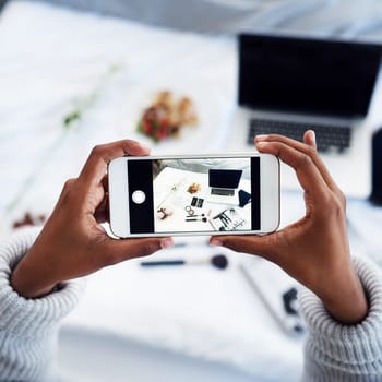Person, hands and cellphone screen with photography in home as content creator, beauty or influencer. Smartphone, makeup and bedroom for online communication or small business, top view or laptop.