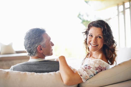 Portrait, happy woman and couple on sofa in home together for love, connection or relax in living room. Face, man and smile of mature partner in lounge for care, commitment and healthy relationship.