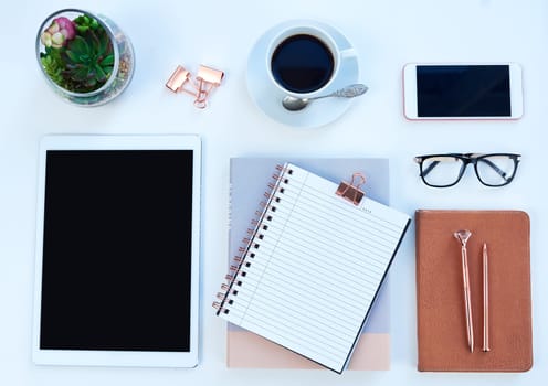 Tablet, smartphone and notebook or above, student workspace and mockup for online elearning station. Blog, pen and technology aesthetic for social media, website and internet display with coffee.