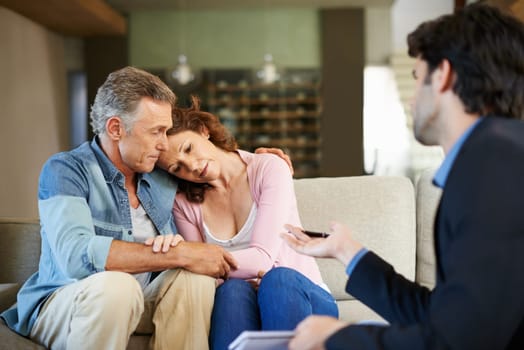 Mature couple, therapist and support in house for relationship for depression in health, stress and advice. Man, woman and psychologist for talking, hug or embrace in lounge with counsellor in home.