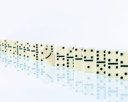 Domino piece stopping domino effect falling. Concept with a solution and intervention.