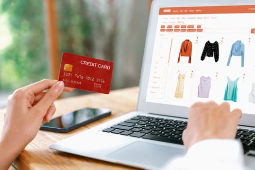Woman shopping online on internet marketplace browsing for sale items for modern lifestyle and use credit card for online payment from wallet protected by uttermost cyber security software