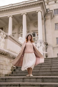 woman in elegant coat and hat against an intricate architectural backdrop, harmoniously blending modern fashion with historical allure. The soft daylight adds to its timeless appeal