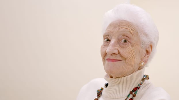 Old woman smiling looking at the camera with copy space