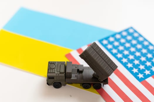 military vehicle and flags of the USA and Ukraine. Defeat of Russia in war in Ukraine concept. High quality photo