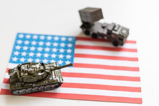 Miniature toy soldiers in battle scene with american flag background , Memorial Day concept. High quality photo