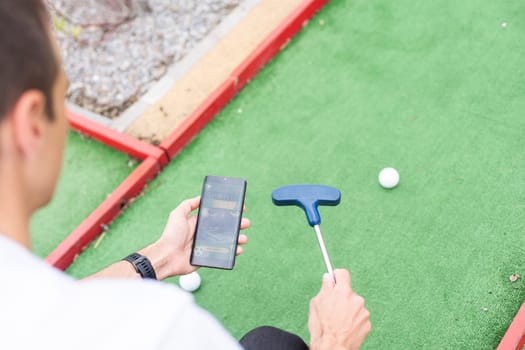 Touch screen in hand, tablet on golf club. smartphone with a sports betting application. High quality photo