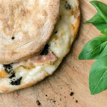 Covered pizza. Italian pinsa romana and scrocchiarella. Gourmet italian cuisine. Traditional dish in italy.