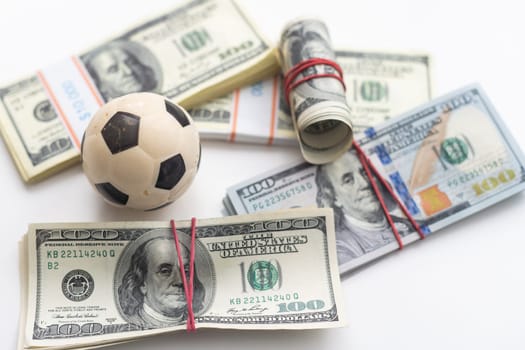 soccer ball over a lot of money. corruption football game. Betting and gambling concept. wold cup. High quality photo
