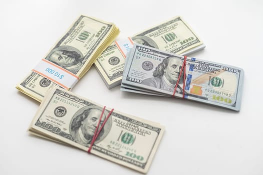 roles dollar notes in front of white background. High quality photo