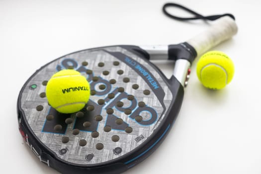 Ukraine Kyiv, 30.03.2024: Padel racket adidas and padel ball on a green court. High quality photo