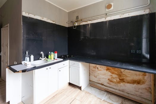 an old style kitchen room with white tiled walls. High quality photo