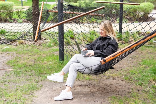 woman with laptop in hammock. High quality photo