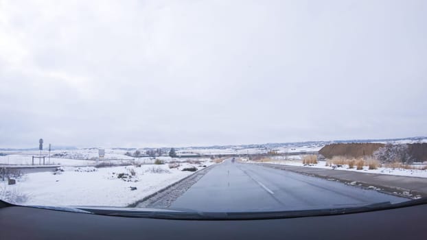 The open highway invites a peaceful drive, with snow-clad pines lining I-25 as the journey continues from Denver towards Colorado Springs on a snowy day.