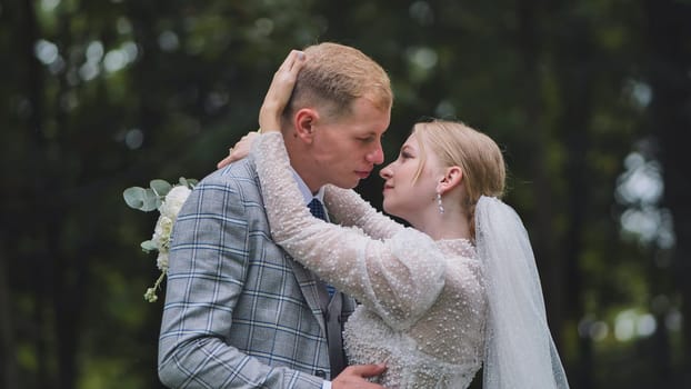 The bride and groom are outdoors