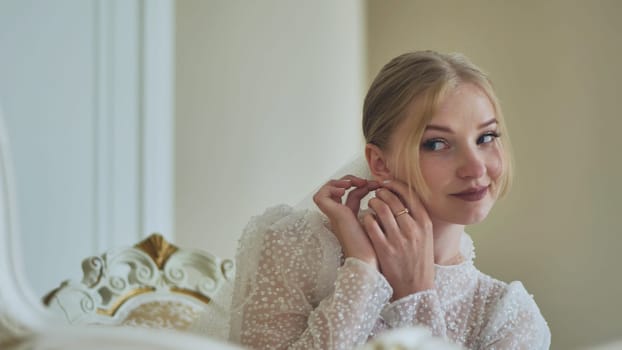 The bride corrects her earring