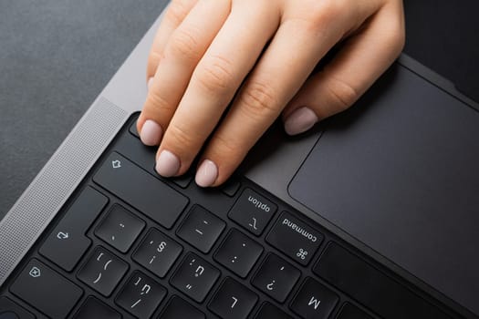 BERLIN, GERMANY - APRIL 14 2024: Female keeps fingers on arrows on keyboard for playing games.