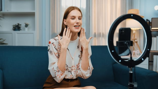 Woman influencer shoot live streaming vlog video review makeup prim social media or blog. Happy young girl with cosmetics studio lighting for marketing recording session broadcasting online.