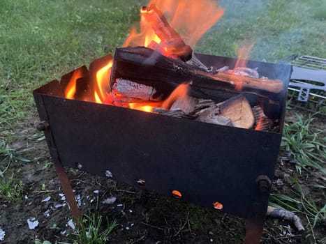 The barbecue grill is lit for the cooking outdoors