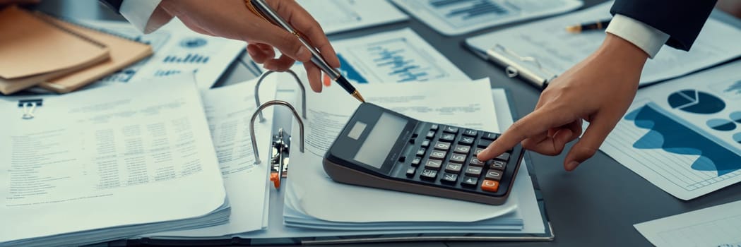 Auditor and accountant team working in office, analyze financial data and accounting record with calculator. Accounting company provide finance and taxation planning for profitable cash flow. Insight