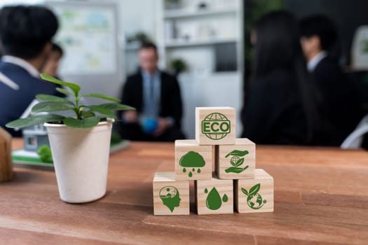 ECO symbol on wooden cube arranged for alternative clean energy utilization and implementation in business concept for greener sustainable Earth with corporate social responsibility policy. Quaint