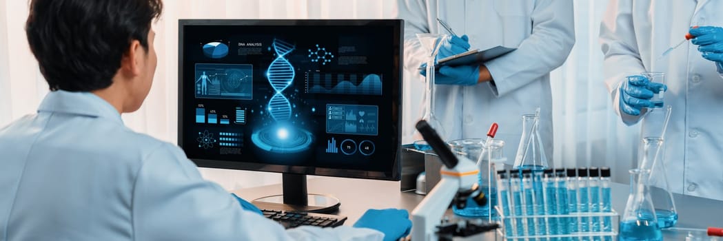 Dedicated scientist group working on advance biotechnology computer software to study or analyze DNA data after making scientific breakthrough from chemical experiment on medical laboratory. Neoteric