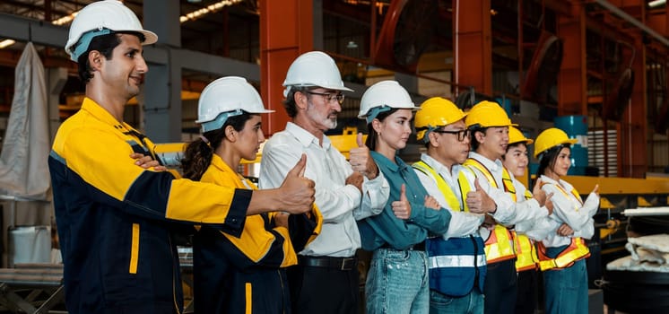 Confident and smiling lineup of factory worker, engineer, manager and foreman stand on-site within heavy industrial manufacturing factory with sense of teamwork and determination Panorama Exemplifying