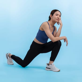 Young attractive asian woman in sportswear stretching before fitness exercise routine. Healthy body care workout with athletic woman warming up on studio shot isolated background. Vigorous