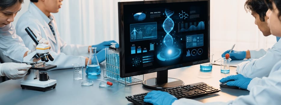 Dedicated scientist group working on advance biotechnology computer software to study or analyze DNA data after making scientific breakthrough from chemical experiment on medical laboratory. Neoteric