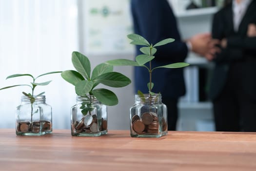 Organic money growth investment concept shown by money savings in glass jar. Financial investments rooted and cultivating wealth in harmony with nature. Quaint