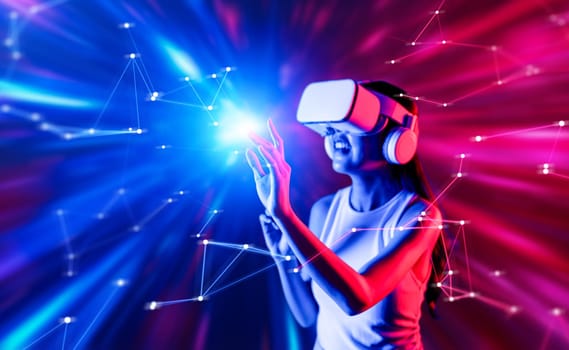 Smart female standing surrounded by neon light wearing VR headset connecting metaverse, future cyberspace community technology. Elegant woman using finger touch virtual reality object. Hallucination.