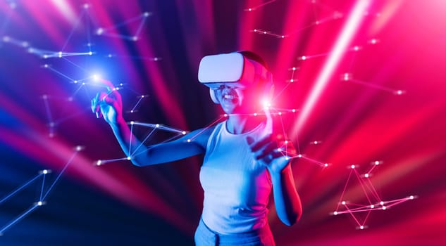 Smart female standing in cyberpunk style building in meta wear VR headset connecting metaverse, future cyberspace community technology, Woman use finger touching virtual reality object. Hallucination.