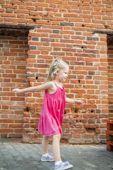 Child with hearing problem and cochlear implant dance in street, deaf kid began to hear. Hearing loss in childhood and treatment concept. Copy space and empty place for text.