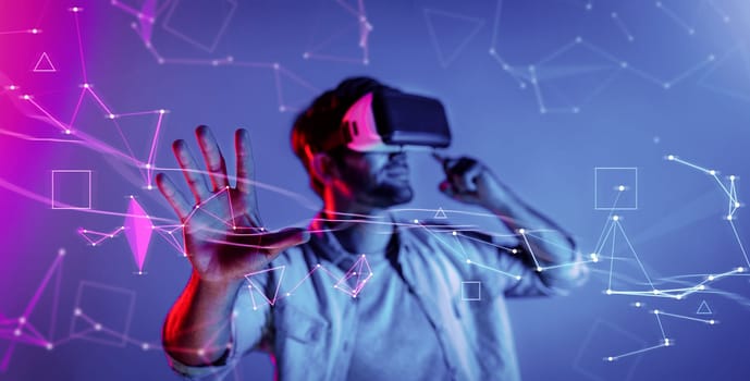 Smart man looking data or connecting with big data or virtual reality by using goggle or VR headset. Caucasian person exploring metaverse world and touching simulated program. Technology. Deviation.