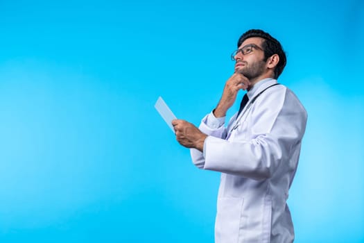 Caucasian smart doctor looking application form while thinking about medical theory. Professional doctor wearing glasses and lab coat while holding clipboard and standing with confident. Deviation.