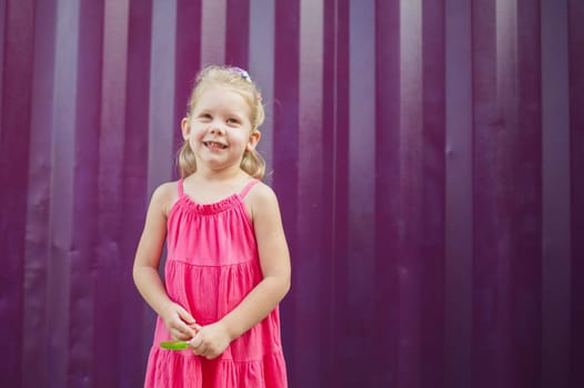 Child girl with hearing aids and cochlear implants having fun outdoor speak and playing. Copy space and empty place for advertising.