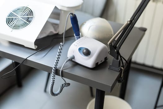 Electric manicure machine on table. Drill for manicure.