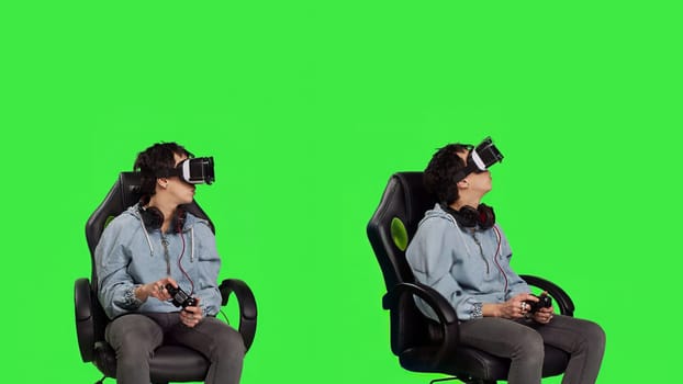 Woman playing video games using virtual reality headset in studio, enjoying cyberspace 3d gaming tournament against greenscreen backdrop. Gamer having fun with vr glasses. Camera B.