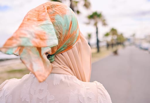 Fashion, walking and back of Muslim woman in city with style, trendy clothes and casual outfit in Saudi Arabia. Religion, travel and Islamic person with confidence, pride and hijab on summer weekend.