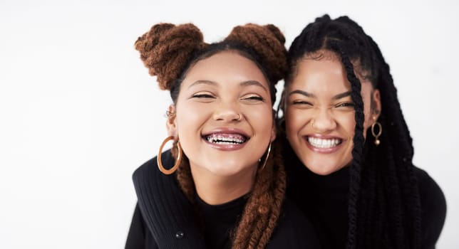 Lesbian couple, portrait and fashion in studio with hug for style inspiration, happiness and love together. Serious, lgbt and black people with embrace for support, relationship and braids with smile.