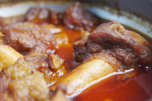 traditional Indian curry lamb masala in a bowl on table.