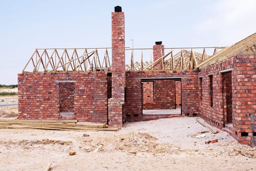 House, building and new real estate for construction, development and dream home project. Property, brick wall and architecture with structure frame, worksite and suburban improvement and design.
