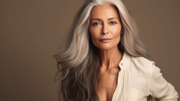 Elegant, elderly, chic Latino, Spain woman with gray long hair and perfect skin, on a brown background, banner. Advertising of cosmetic products, spa treatments, shampoos and hair care products, dentistry and medicine, perfumes and cosmetology women