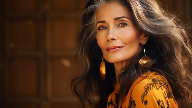 Elegant, elderly, chic latino, Spain woman with gray long hair and perfect skin, golden background, banner. Advertising of cosmetic products, spa treatments, shampoos and hair care products, dentistry and medicine, perfumes and cosmetology for women