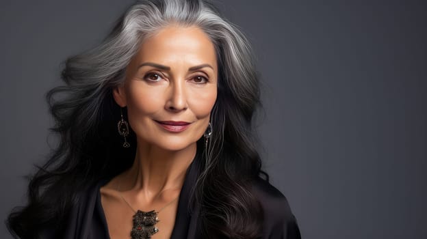 Elegant, elderly, chic latino, Spain woman with gray long hair and perfect skin, silver background, banner. Advertising of cosmetic products, spa treatments, shampoos and hair care products, dentistry and medicine, perfumes and cosmetology for women