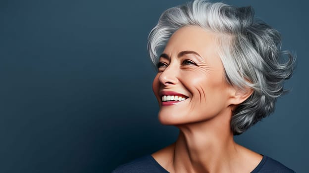 Elegant, smiling elderly, chic latino, Spain woman with gray hair and perfect skin, blue background banner. Advertising of cosmetic products, spa treatments, shampoos and hair care products, dentistry and medicine, perfumes and cosmetology for women