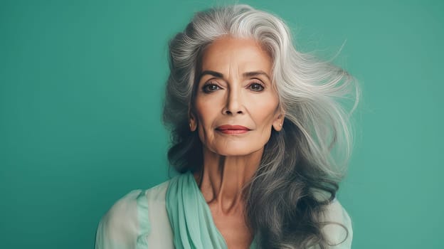 Elegant, elderly, chic latino, Spain woman with gray long hair and perfect skin, green background, banner. Advertising of cosmetic products, spa treatments, shampoos and hair care products, dentistry and medicine, perfumes and cosmetology for women