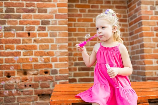 Child with hearing problem and cochlear implant dance in street, deaf kid began to hear. Hearing loss in childhood and treatment concept. Copy space and empty place for text.